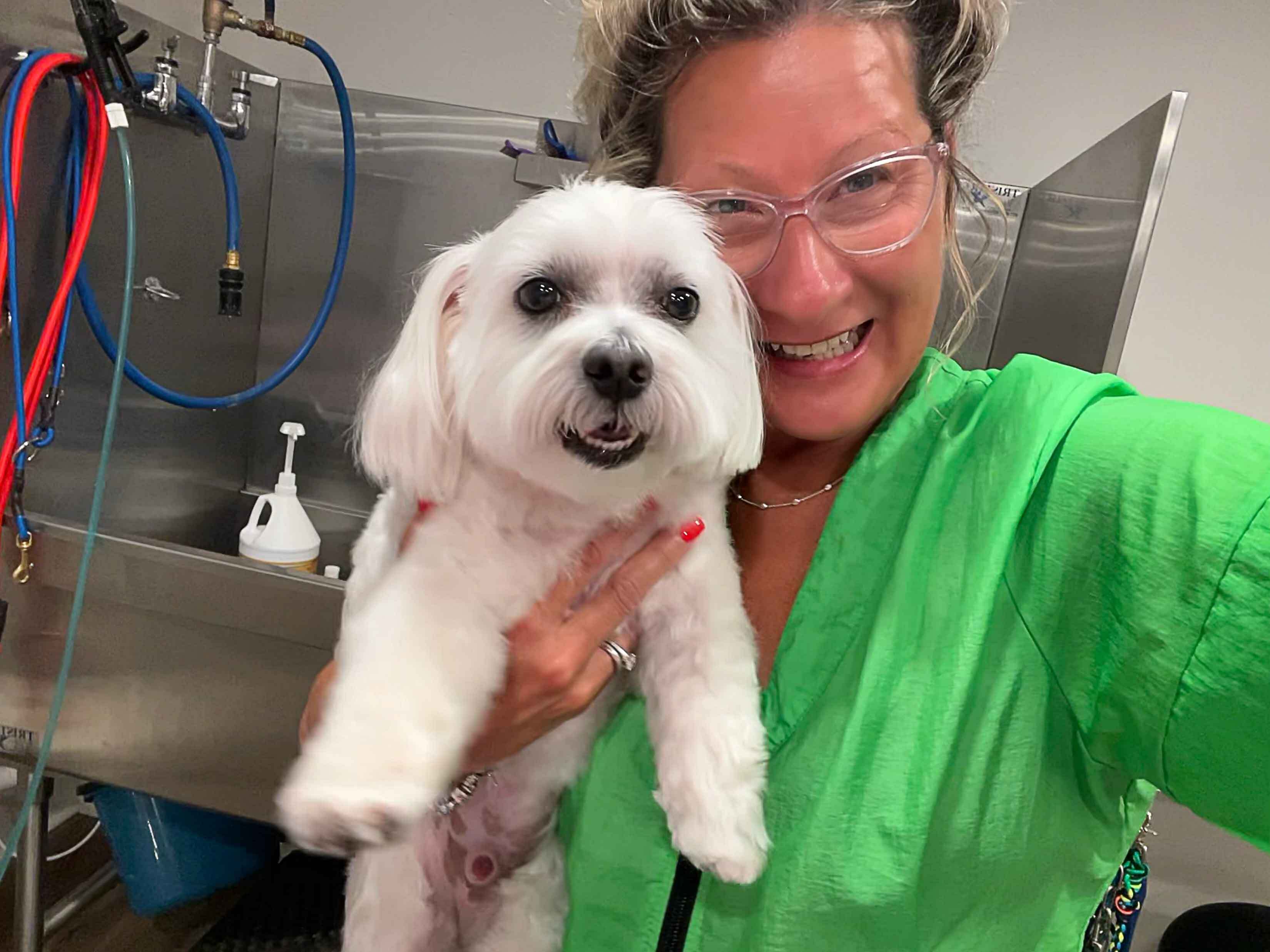 Amy Leigh holding up a dog